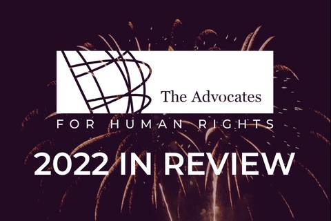 [ai] The logo of The Advocates for Human Rights displayed against a background of fireworks. Below, the text reads '2022 IN REVIEW' in bold white letters.
